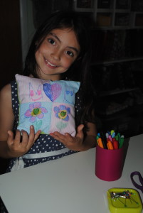 girl showing a handmade pillow