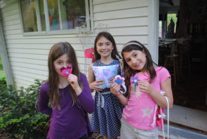 girls showing their handmade mother's day gifts they sewed
