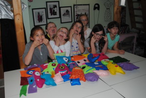 girls making silly faces with their handmade monsters
