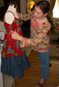 Sewing student Rebecca making her own denim tiered skirt and rust colored pretty summer top.