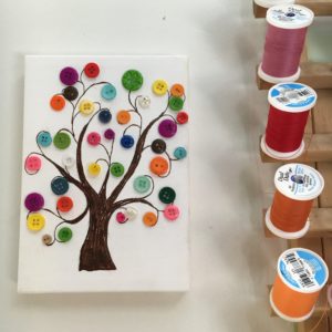 A nice handcrafted button tree canvas birthday gift for Mrs. Harris made by student Marina.