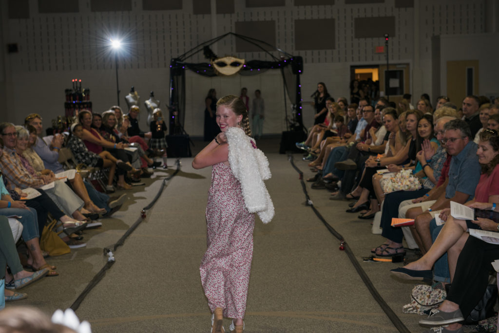 young fashion design student walking the runway
