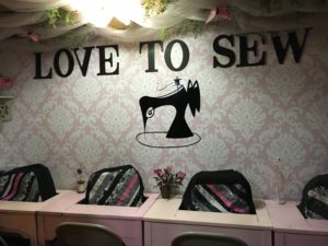 Love to Sew Sewing Studio, a pink, black, and white sewing studio.