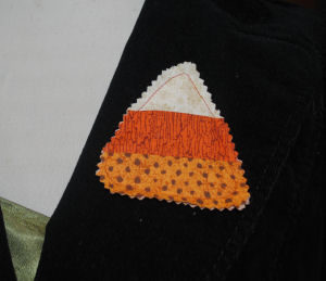 An easy to sew and handmade Halloween pin featuring a rustic candy corn
