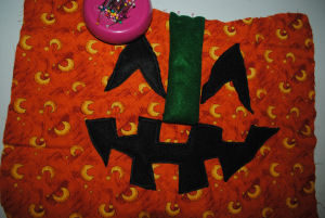 A quilted handmade pumpkin craft for Halloween that is easy to sew