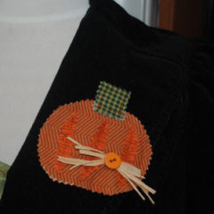 An easy to sew and handmade Halloween pin featuring a rustic pumpkin