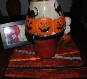 A candle on top of an easy to sew handmade Halloween placemat craft