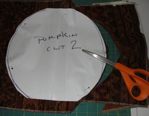 A Halloween craft that is easy to sew and handmade; it features a tapestry pumpkin