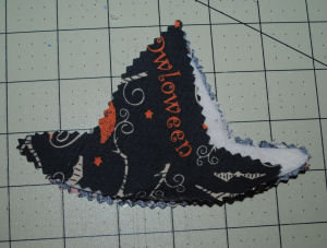 An easy to sew and handmade Halloween decoration featuring a witch hat candle ring