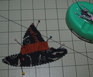 A handmade Halloween decoration featuring a witch hat candle ring that is easy to sew and has a free tutorial