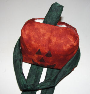 sewn stem inside top of pumpkin doll