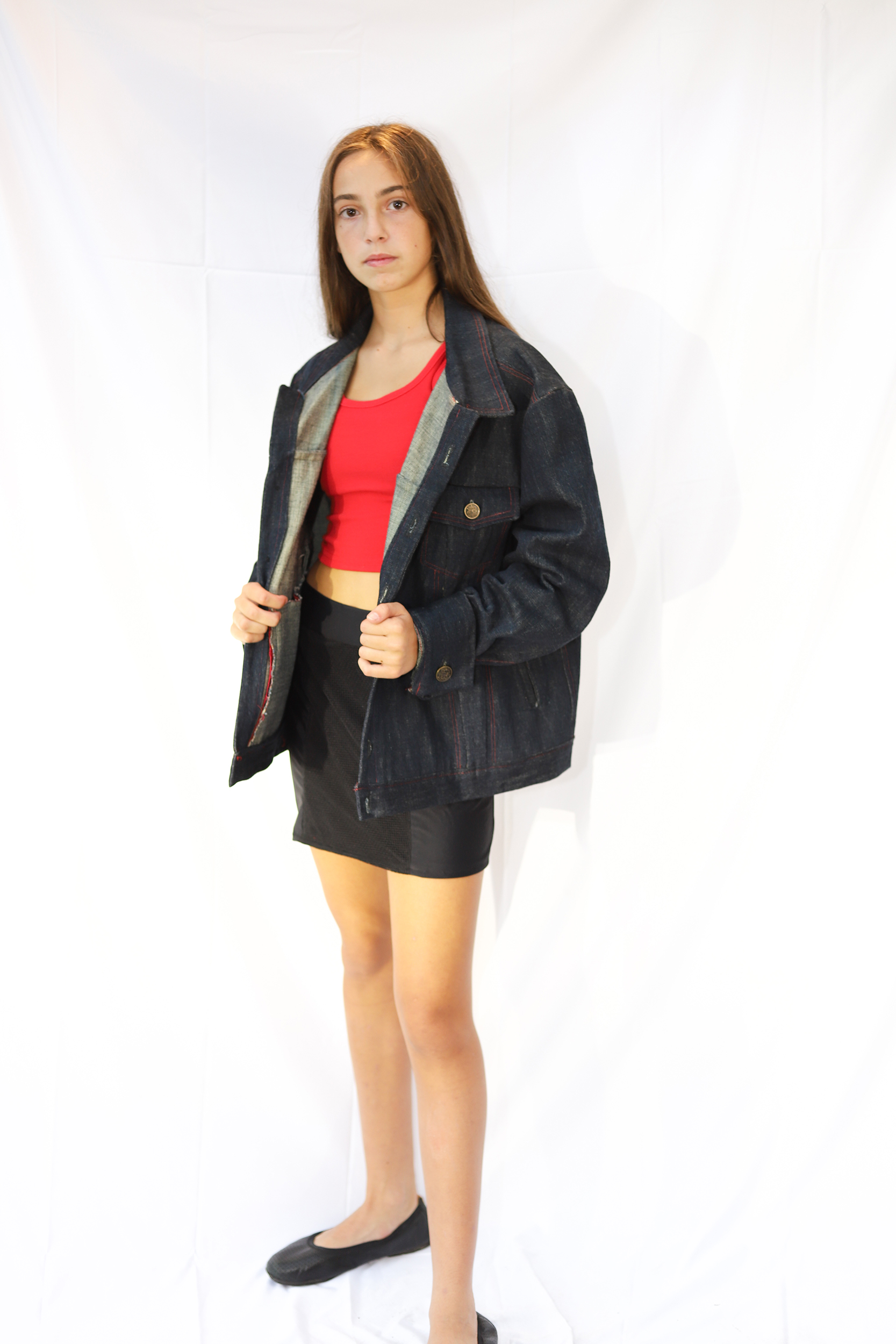 front view of girl posing in a oversized denim jacket and skirt