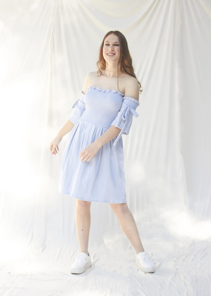 Girl in blue ruched dress with detachable sleeves