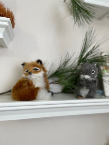 baby fox and squirrel made from faux fur in nursery on a shelf