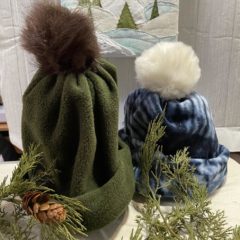 fleece fabric sewn together to make a hat and a pom pom added on top.