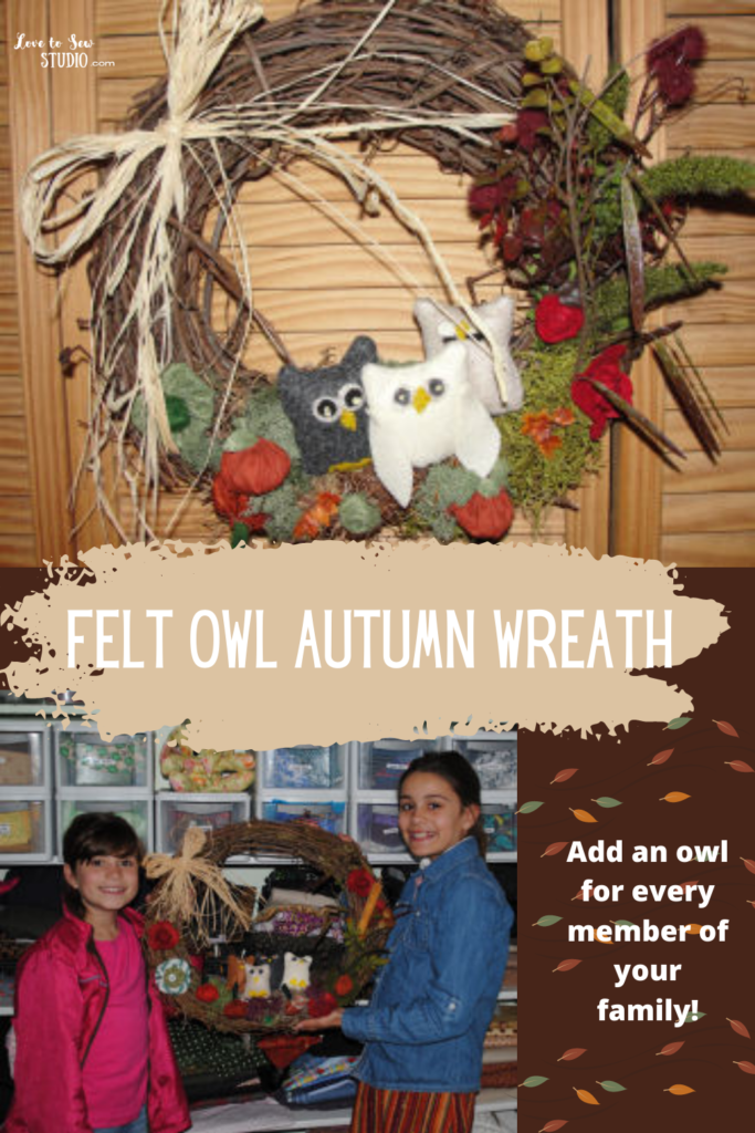 Felt owls and other shrubbery added to a wreath to make a rustic autumn wreath