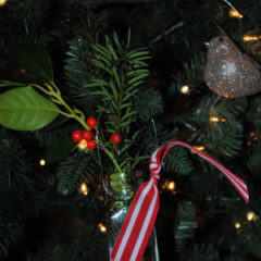 A salt jar with greenery hung up as an ornament