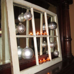 Christmas balls hung onto a repurposed window frame