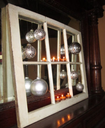 Christmas balls hung onto a repurposed window frame