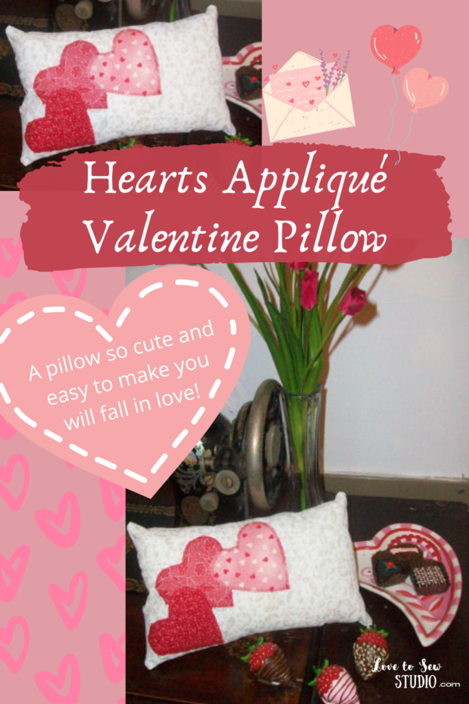 a white pillow with hearts appliqué on it.   