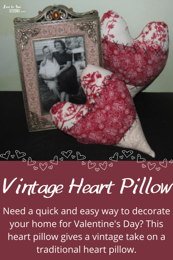 vintage valentine fabric sewed together to make a heart pillow