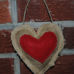 burlap and red fabric made into hearts and put together to make a hanging heart
