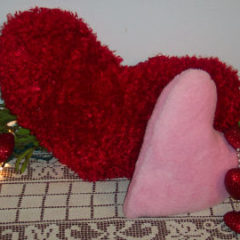 red fur fabric made into a big heart pillow
