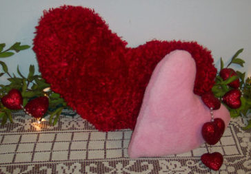 red fur fabric made into a big heart pillow