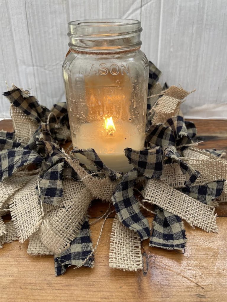 pieces of burlap and checkered fabric tied around a ring to put around a candle