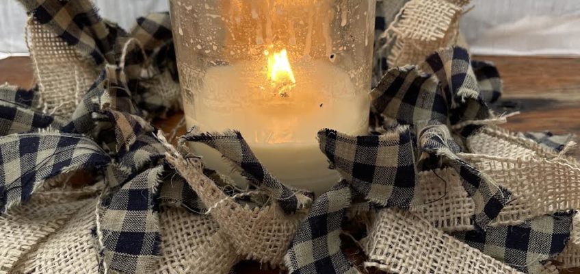 pieces of burlap and checkered fabric tied around a ring to put around a candle