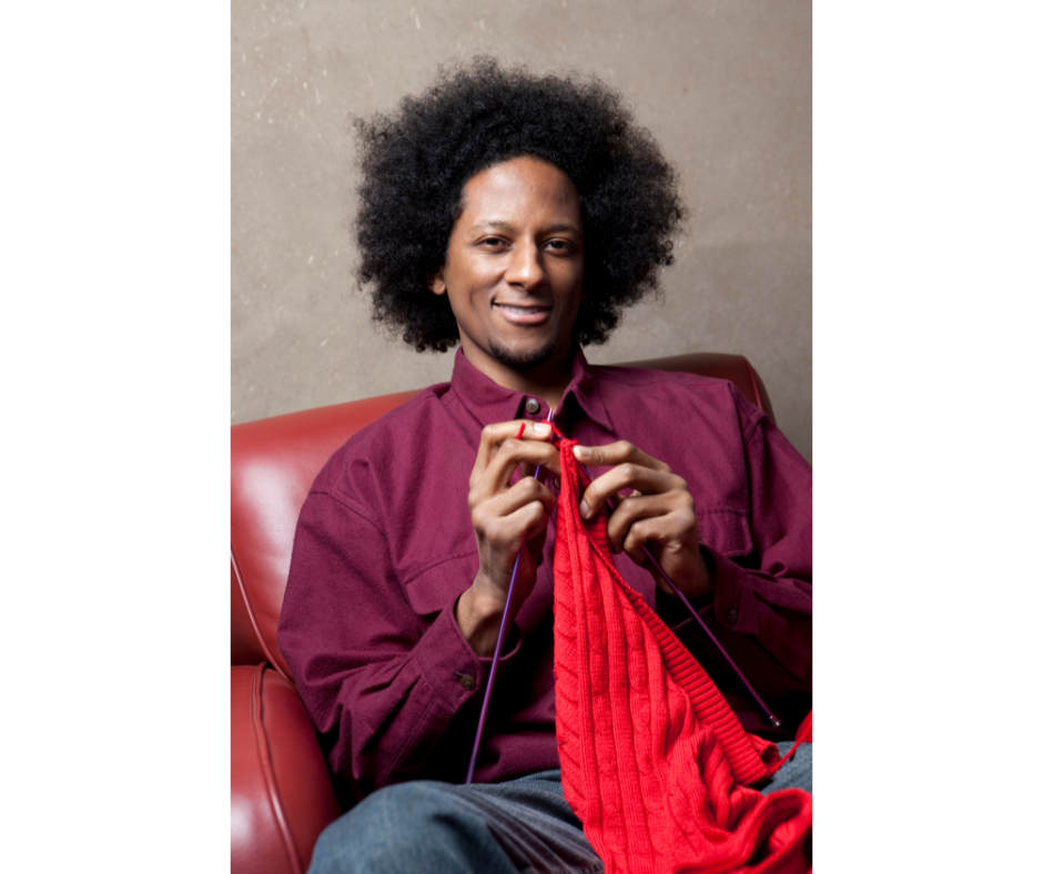 man working on a knitting project
