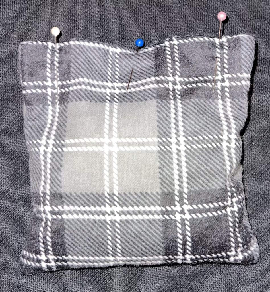 flannel fabric made into hand warmers with organic cherry pits inside