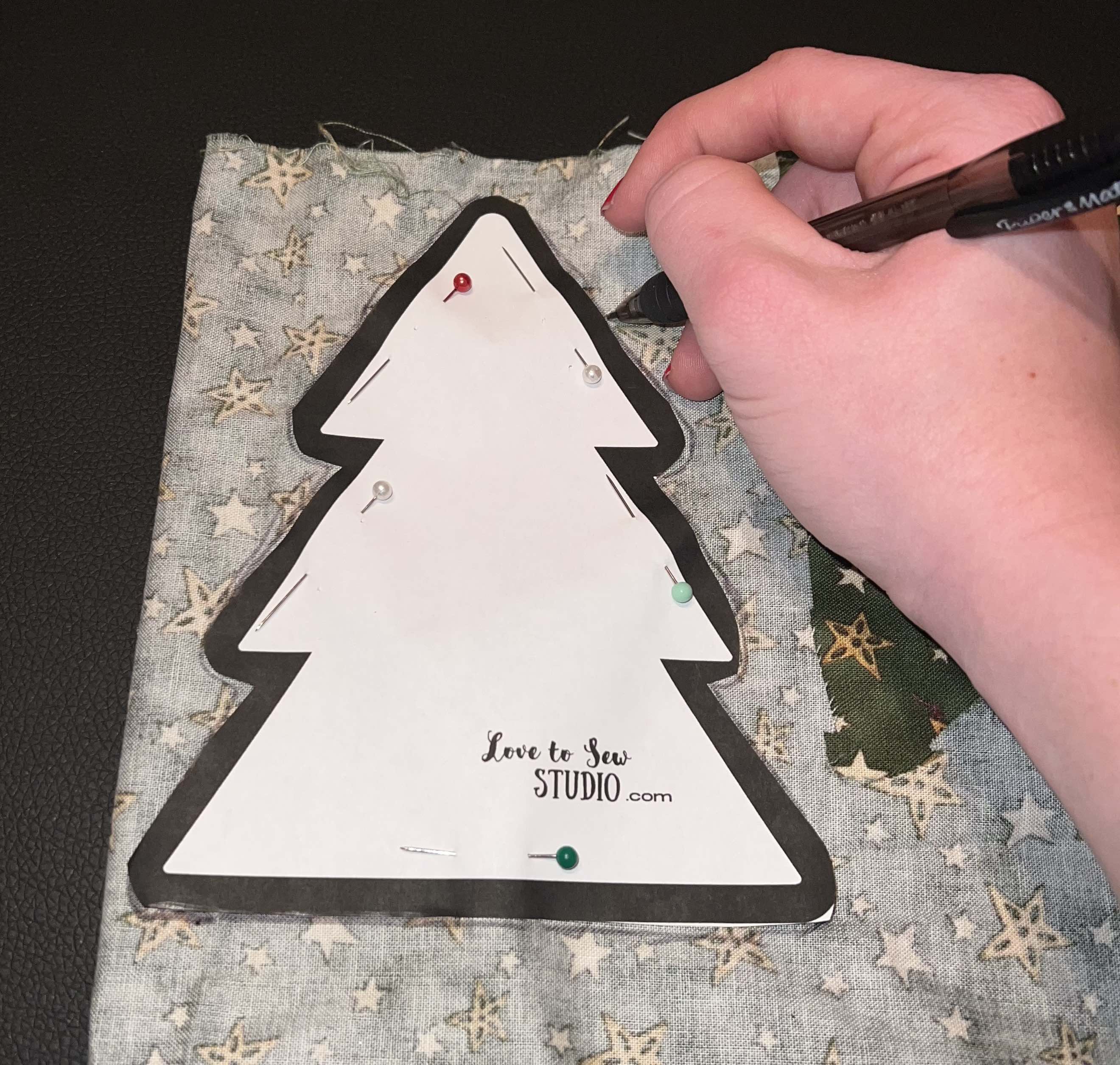 fabric made into a winter tree and placed on a wooden round