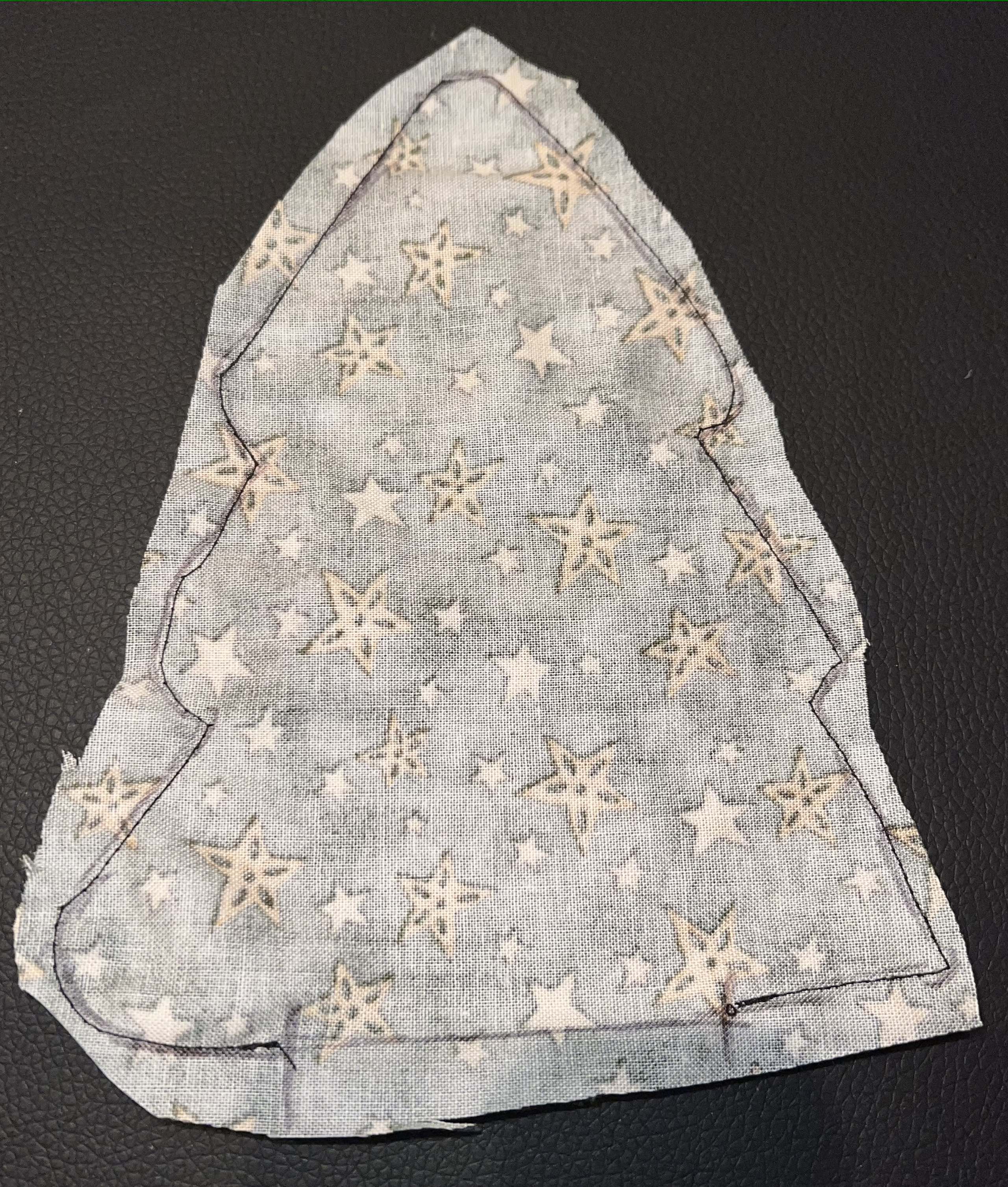 fabric made into a winter tree and placed on a wooden round